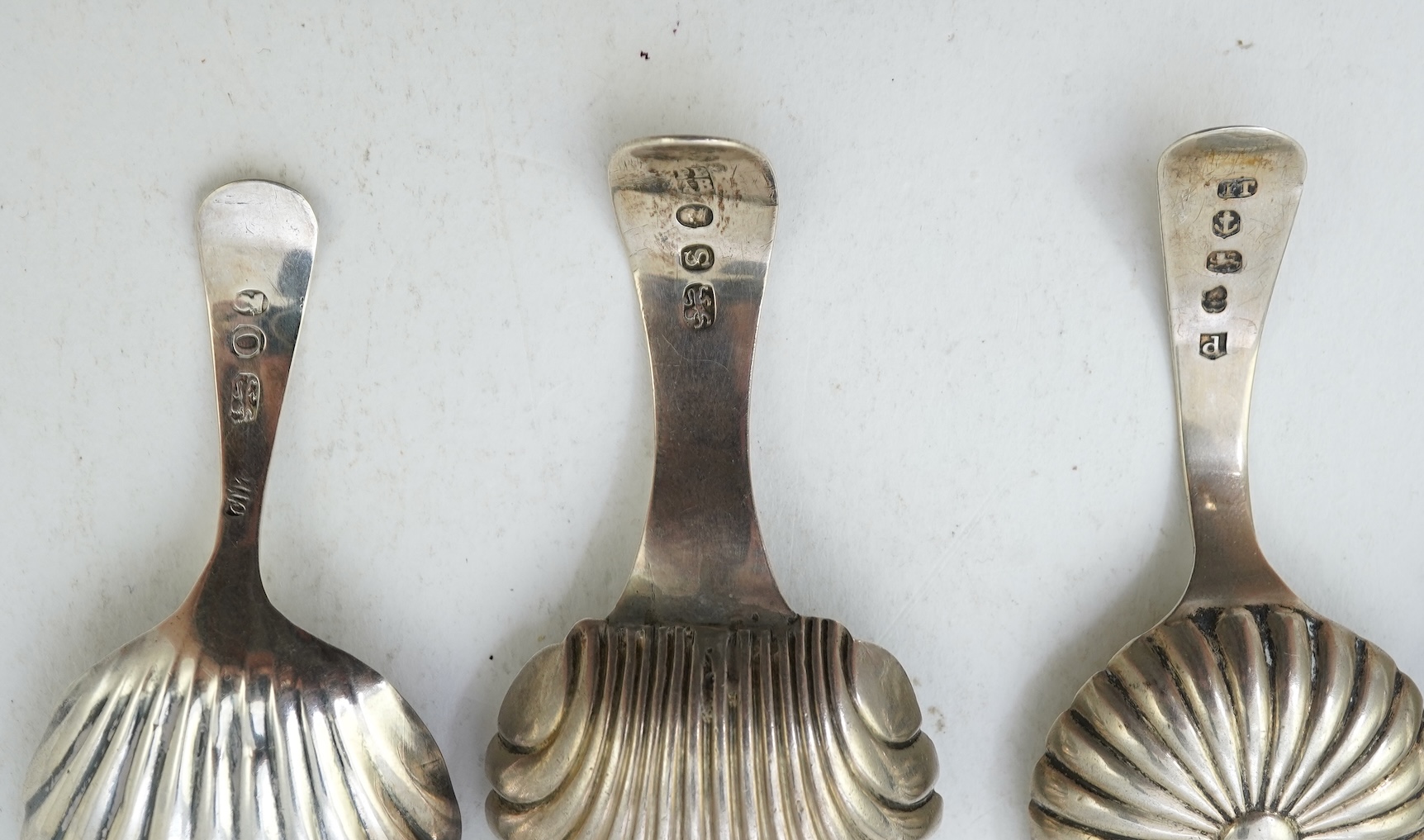 Ten assorted mainly 19th century silver and white metal caddy spoons, with shell or fluted bowls